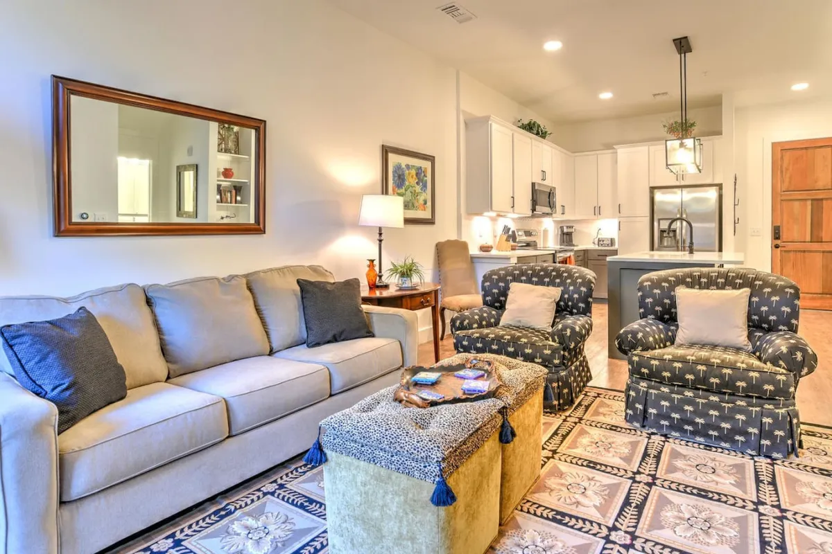 A cozy, inviting living area with a sofa, accent chairs, coffee table, and decorative items. The space is arranged for comfort and conversation, perfect for curling up with a book, sharing a glass of wine, or hosting friends.